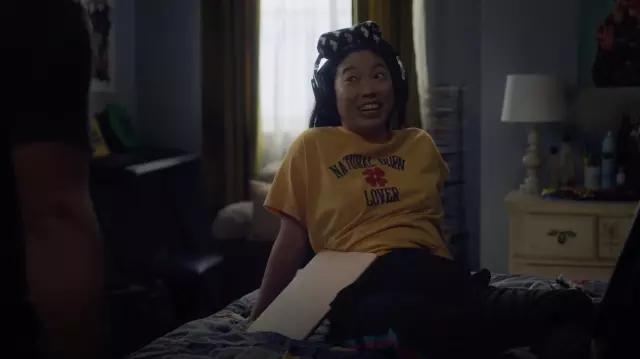 Levi's Graphic Varsity "Natural Born Lover" in yellow t-shirt worn by Nora (Awkwafina) as seen in Awkwafina is Nora From Queens outfits (S02E08)